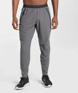 OEM yüksek kalite Slim Fit Spandex Polyester Jogger erkekler için toptan fermuar cep özel Logo hafif Sweatpants