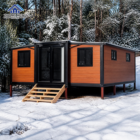 Maison modulaire extensible à double aile de 20, 30 ou 40 pieds avec porte d'entrée centrale en verre pour maison-conteneur de jardin