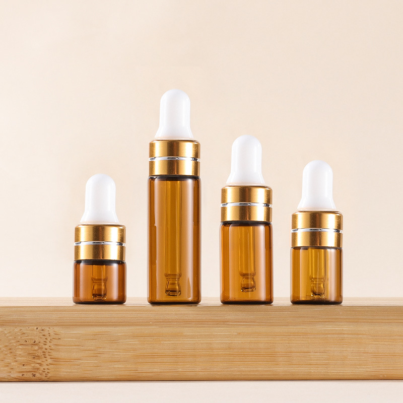 Tapa cuentagotas ámbar + dorada con línea plateada + tetina blanca