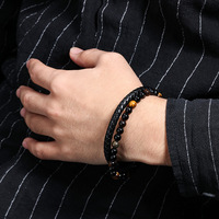 Bracelet en corde de peau de vache à la mode pour hommes de style européen et américain Bracelet en pierre naturelle perlée en œil de tigre volcanique