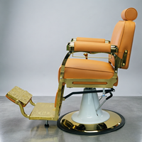 Fauteuil de barbier de luxe avec cadre plaqué or, revêtement en cuir PU orange-brun, appui-tête réglable, inclinable, équipement de salon de coiffure
