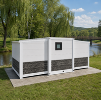 Maison conteneur pliable extensible en faux pierre blanche avec fenêtre à cadre noir pour le glamping et l'hébergement en bord de rivière