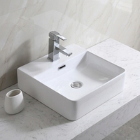 Lavabo de salle de bain moderne en céramique blanche polie avec meuble sous-évier et lavabo artistique intégré au comptoir