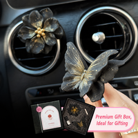 Diffuseur de parfum de luxe noir et or en forme de papillon camélia pour grille d'aération de voiture