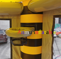 Château gonflable commercial noir et jaune rayé avec double toboggan, idéal pour les entreprises de location