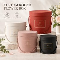 Boîte cadeau cylindrique rigide en carton texturé avec poignée en corde ronde, couvercle et base personnalisés avec logo, pour l'emballage de fleurs