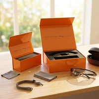 Boîte cadeau en carton rigide orange avec logo personnalisé, fermeture magnétique et insert en mousse