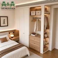 Système de dressing personnalisable pour toute la maison avec armoire d'angle, portes crème, poignées en laiton et table de chevet intégrée