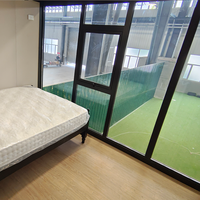 Casa Contenedor Expandible de Dos Pisos con Estructura de Acero Corrugado Negro, Iluminación LED, Villa Prefabricada, Venta al Por Mayor de Fábrica