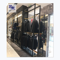 Étagère d'exposition moderne personnalisée avec éclairage LED pour les boutiques de vêtements pour hommes, avec construction en verre et en métal