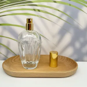 Frascos de perfume redondos de vidrio de 50ml con tapa delgada dorada