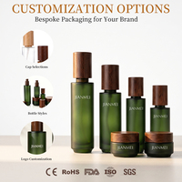 Flacons de crème pour les yeux en verre vert foncé, flacons de lotion et de spray avec bouchon en bois, fabrication directe d'usine OEM, pour ensemble de soins de la peau