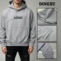 Sweat-shirt en coton gris chiné pour homme, coupe oversize, avec logo personnalisé, poche kangourou, épaules tombantes et poignets côtelés, idéal pour l'hiver