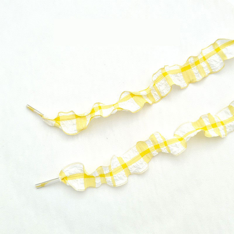 1 paire de lacets en maille à carreaux jaunes