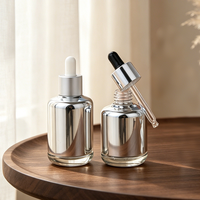 Flacon compte-gouttes en verre argenté métallisé, flacon de sérum de luxe à base lourde, flacon d'huile essentielle chromé avec logo personnalisé, emballage