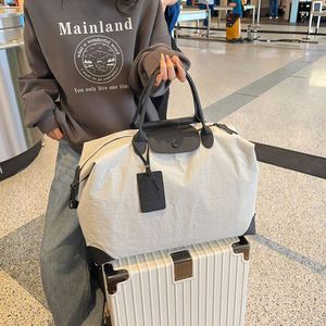 Sacs de voyage unisexes personnalisés avec logo de marque, sacs de rangement pour bagages de couleur unie simple, sacs fourre-tout de grande capacité pour voyager - Product Image 1