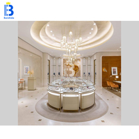 Vitrine de présentation de bijoux circulaire de luxe en or rose sur mesure avec éclairage LED pour boutique de bijoux, kiosque