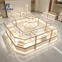 Kiosque de présentation de bijoux de luxe sur mesure en or rose, vitrine à bijoux en verre éclairée par LED, comptoir d'îlot pour bijouterie de centre commercial