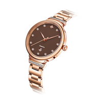 Montre à quartz de luxe moderne et personnalisée pour femme, avec verre, bracelet en acier inoxydable, lunette sertie de diamants, aiguilles en forme de feuille, date et fermoir papillon
