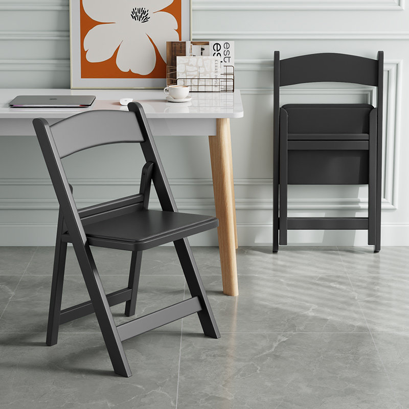 Black upholstered folding chair with reinforced seat.
