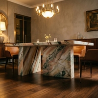 Table à manger portable 6 places en marbre onyx coloré, design moderne et vibrant, avec plateau rond et pieds inclinés, pour la maison et les halls d'hôtels de luxe