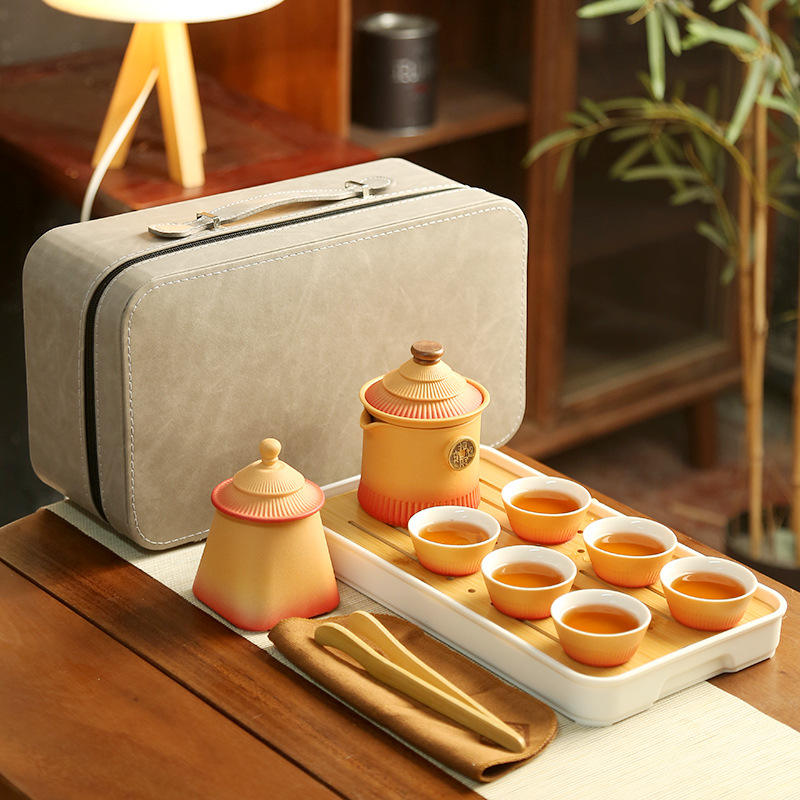 One orange teapot, six cups, plus a plate, a jar, and a towel