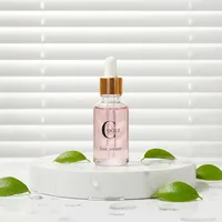 Flacons cosmétiques vides en verre cylindrique rose doré de 30 ml et rose translucide de 50 ml avec impression sérigraphique