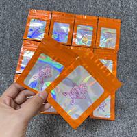 Bolsa de plástico para embalaje de Mylar con cremallera láser holográfica naranja transparente a prueba de olores resellable de grado alimenticio con logotipo personalizado