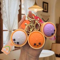 Balle anti-stress scintillante colorée en forme de dumpling, jouet anti-stress très populaire, porte-clés en gros