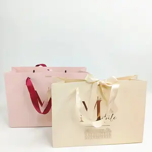 Sacchetto di carta regalo di lusso con stampa personalizzata all'ingrosso rosa pesca stampata con manico e fiocco, sacchetti di carta di lusso con il tuo logo