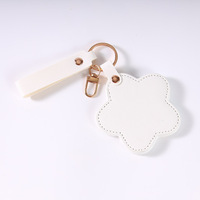 Miroir de maquillage en PU haut de gamme personnalisé européen et américain avec fleur rotative, portable pour voyage, porte-clés.