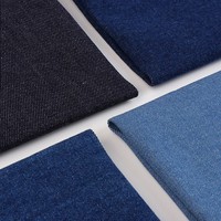 Tela vaquera elástica lavada de sarga, tela de mezclilla cruda tejida, tela lisa para pantalones, vaqueros, chaquetas, bolsos, zapatos y sombreros de estilo moderno.