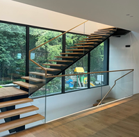 Escalier droit moderne en bois massif flottant avec structure en acier et garde-corps en verre transparent, design ouvert