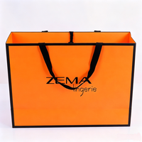 Sacs en papier orange de haute qualité pour vêtements, avec ruban gros-grain imprimé, logo personnalisé, taille et couleur sur mesure, grande capacité, emballage cadeau