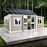 Maison conteneur extensible de 20 pieds à énergie solaire, préfabriquée, autonome, avec panneaux gris et base en béton, pour la vie en forêt