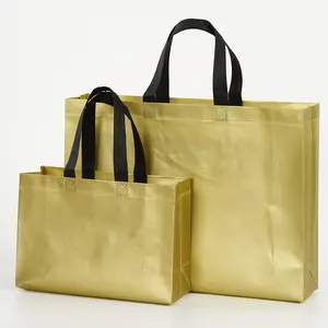 Bolsas de compras grandes no tejidas laminadas en oro listas para enviar con asa negra bolsas de mano no tejidas de PP de oro metálico en stock