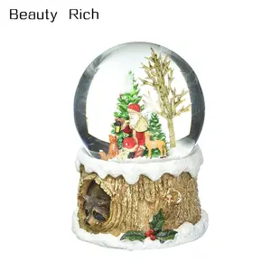 100mm Snow Globe Musical Glitter Dome, Features Santa with Woodland Animals on a Tree Like Base with a Racoon Peeking Out