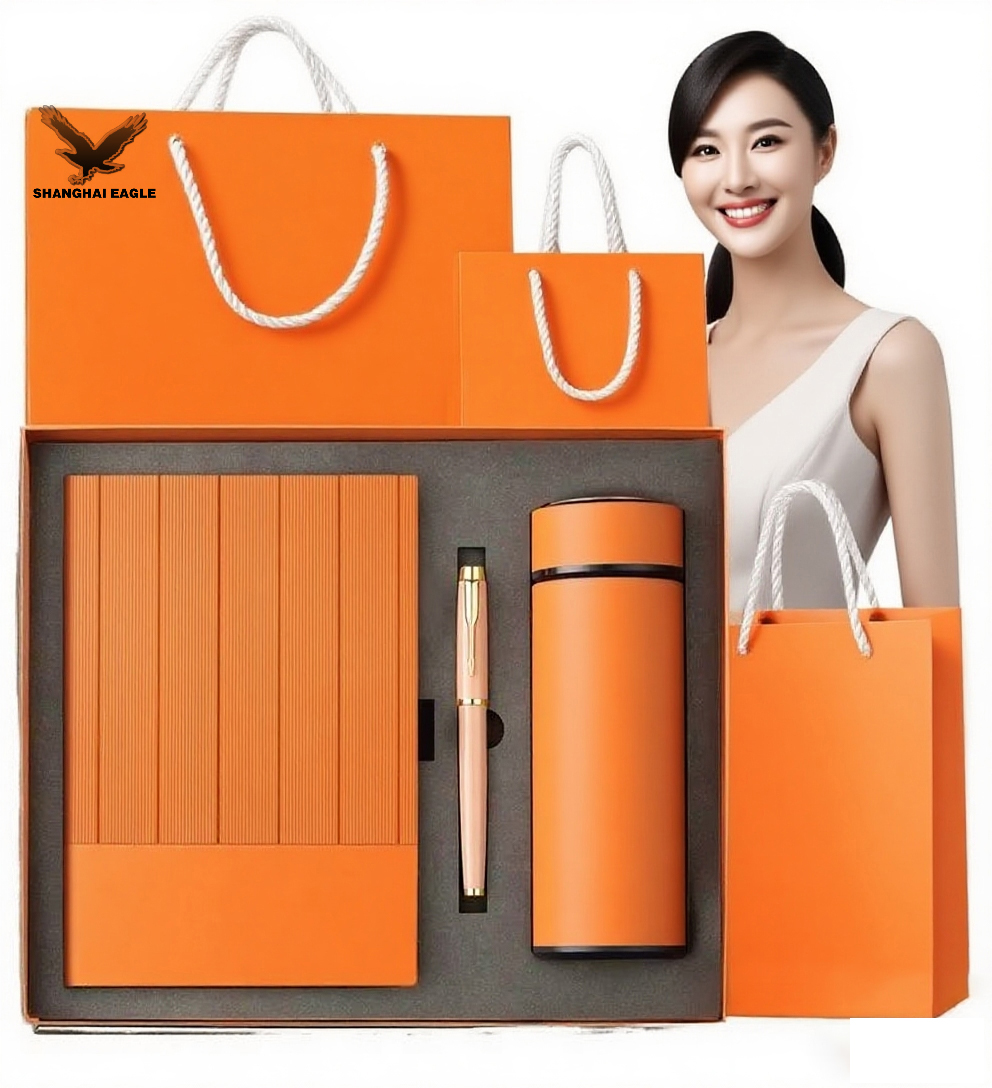 Cuaderno naranja+bolígrafo+vaso