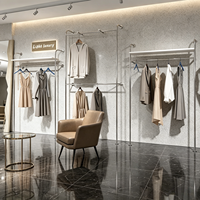 Portant à vêtements moderne en acier inoxydable autoportant avec étagères et double tringle pour boutique de vêtements et showroom