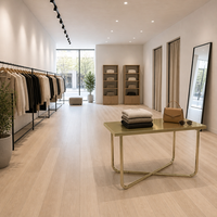 Comptoir de présentation en métal doré avec base en X pour magasin de vêtements, fourniture d'usine OEM ODM