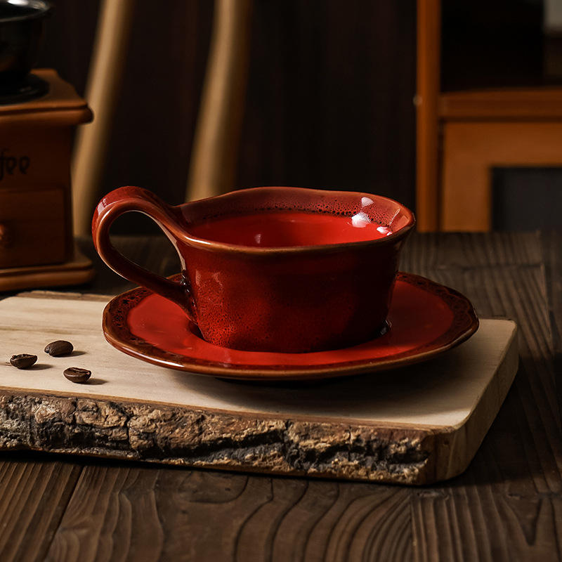Red kiln-fired coffee cups and saucers