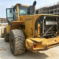 Chargeuse multi-usages Volvo L180F d'occasion robuste à large application avec attache rapide et divers accessoires pour travaux de fondation sur chantier