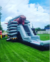 Château gonflable dinosaure 2026 avec toboggans aquatiques pour jardin, à vendre