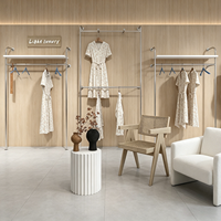 Portant à vêtements moderne en acier inoxydable autoportant avec étagères et double tringle pour boutique de vêtements et showroom