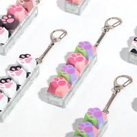 Porte-clés pendentif patte de chat colorée et mignonne, jouet anti-stress imprimé patte de chat, clavier à boutons pour sac à dos