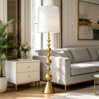 Lampadaire sculptural doré à abat-jour cylindrique blanc, base conique à tiges empilées, lampe sur pied moderne pour salon et hôtel