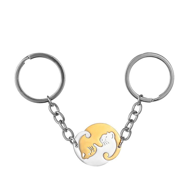 Round gold and silver cat keychain pair