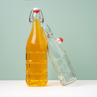 Bouteille en verre transparente de 1 litre avec couvercle à clapet en métal pour jus pressé à froid, kombucha et stockage de boissons fermentées