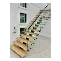 Escalier intérieur en bois foncé à une seule montante, avec poutre en acier