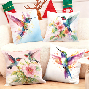 Des colibris et des fleurs aux couleurs vives ornent des coussins douillets dans un décor festif. - Product Image 1